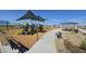 Modern playground with shaded play structures and benches at 37600 N Cowboy Ln, San Tan Valley, AZ 85140
