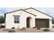 One-story home with brown garage door and desert landscaping at 37600 N Cowboy Ln, San Tan Valley, AZ 85140