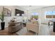 Open living space with a large TV and comfortable seating at 7449 S 75Th Dr, Laveen, AZ 85339