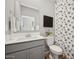 Well-lit bathroom with gray vanity and patterned shower curtain at 7449 S 75Th Dr, Laveen, AZ 85339
