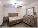 Cozy bedroom with a wooden bed frame and dresser at 18202 N Cave Creek Rd # 115, Phoenix, AZ 85032
