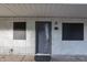 Building exterior featuring a gray door and stucco siding at 18202 N Cave Creek Rd # 115, Phoenix, AZ 85032