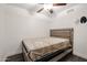 Simple bedroom with a double bed and ceiling fan at 18202 N Cave Creek Rd # 115, Phoenix, AZ 85032