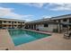 Community pool with surrounding patio furniture and grilling area at 18202 N Cave Creek Rd # 115, Phoenix, AZ 85032