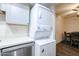 Compact laundry area with stacked washer and dryer at 18202 N Cave Creek Rd # 115, Phoenix, AZ 85032