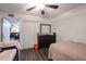 Well-lit bedroom with a bed, dresser, and view of the living room at 18202 N Cave Creek Rd # 115, Phoenix, AZ 85032