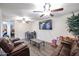 Spacious living room featuring brown leather couches and a large TV at 18202 N Cave Creek Rd # 115, Phoenix, AZ 85032