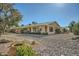 Landscaped backyard with gravel and mature trees at 12946 W Ashwood Dr, Sun City West, AZ 85375