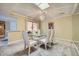 Bright dining room with glass table and seating for six at 12946 W Ashwood Dr, Sun City West, AZ 85375