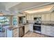 Eat-in kitchen with island, granite counters & view at 12946 W Ashwood Dr, Sun City West, AZ 85375