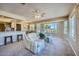 Bright living room with golf course view, comfy seating, and access to kitchen at 12946 W Ashwood Dr, Sun City West, AZ 85375