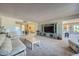 Open living room with a view of the dining area and plenty of natural light at 12946 W Ashwood Dr, Sun City West, AZ 85375