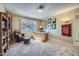 Bright home office featuring a spacious desk and comfortable recliner at 12946 W Ashwood Dr, Sun City West, AZ 85375