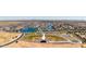 Aerial view of a large community with a lake, baseball field, and many homes at 40010 W Bravo Dr, Maricopa, AZ 85138