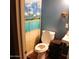 Clean bathroom with toilet, sink and beach-themed shower curtain at 4622 N 71St Ln, Phoenix, AZ 85033