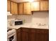 Galley kitchen with wood cabinets, microwave, and double sink at 4622 N 71St Ln, Phoenix, AZ 85033