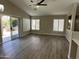 Spacious living room with large windows and ceiling fan at 15075 W Amelia Dr, Goodyear, AZ 85395