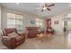 Spacious living room with leather furniture and tiled floors at 22499 W Antelope Trl, Buckeye, AZ 85326