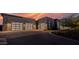 Three-car garage with modern glass garage doors at 30505 N Sage Dr, Peoria, AZ 85383