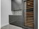Modern wine room with gray cabinetry and a large wine cooler at 30505 N Sage Dr, Peoria, AZ 85383