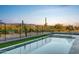Modern rectangular pool with a view of a golf course at 30505 N Sage Dr, Peoria, AZ 85383