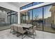 Modern dining room with large windows and gray seating at 30505 N Sage Dr, Peoria, AZ 85383