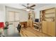 Home office features built-in shelving, a desk, and wood flooring at 3053 E Knoll St, Mesa, AZ 85213