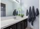 Clean bathroom with vanity, large mirror and dark wood cabinets at 1825 W Ray Rd # 1001, Chandler, AZ 85224