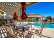 Relaxing poolside seating area with tables and umbrellas at 1825 W Ray Rd # 1001, Chandler, AZ 85224