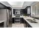 Modern kitchen with stainless steel appliances and dark wood cabinets at 1825 W Ray Rd # 1001, Chandler, AZ 85224