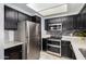 Updated kitchen featuring stainless steel appliances and dark cabinetry at 1825 W Ray Rd # 1001, Chandler, AZ 85224