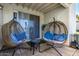 Relaxing patio with hanging chairs and a small table at 1825 W Ray Rd # 1001, Chandler, AZ 85224