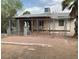 Front view of a single-story house with a chain link fence and landscaping at 107 W 1St St, Eloy, AZ 85131