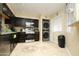 Kitchen with dark cabinets, stainless appliances, and tile floor at 9450 N 95Th St # 219, Scottsdale, AZ 85258