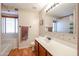 Clean bathroom with wood vanity, large mirror and bathtub at 19820 N 13Th Ave # 283, Phoenix, AZ 85027