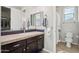 Clean bathroom with a shower/tub combo and dark wood vanity at 27016 N 14Th Ln, Phoenix, AZ 85085