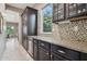Kitchen features dark wood cabinetry and granite countertops at 27016 N 14Th Ln, Phoenix, AZ 85085