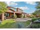 Backyard view of two-story home with lush landscaping at 27016 N 14Th Ln, Phoenix, AZ 85085