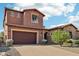 Two-story home with a large garage and well-manicured landscaping at 27016 N 14Th Ln, Phoenix, AZ 85085