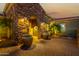 Well-lit entryway with stonework, large urns, and a paved courtyard at 13232 W Los Bancos Dr, Sun City West, AZ 85375