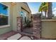 Side entrance with wrought iron gate and stone accents at 13232 W Los Bancos Dr, Sun City West, AZ 85375
