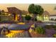 Evening view of a two-story home with stone accents and a landscaped yard at 13232 W Los Bancos Dr, Sun City West, AZ 85375