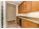 Butlers pantry with granite countertops, wood cabinets, and wine cooler at 13232 W Los Bancos Dr, Sun City West, AZ 85375