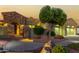 Night view of a house with stone exterior, double garage, and manicured landscaping at 13232 W Los Bancos Dr, Sun City West, AZ 85375