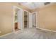 Bedroom with carpet, private bathroom and closet access at 13232 W Los Bancos Dr, Sun City West, AZ 85375