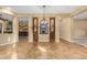Elegant dining room with chandelier and view of kitchen at 13232 W Los Bancos Dr, Sun City West, AZ 85375