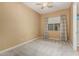 Bright bedroom with window, carpet, and ceiling fan at 13232 W Los Bancos Dr, Sun City West, AZ 85375