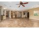 Open living area with tile floors, ceiling fan, and views into other rooms at 13232 W Los Bancos Dr, Sun City West, AZ 85375