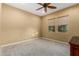 Bright bedroom with ceiling fan and neutral carpeting at 13232 W Los Bancos Dr, Sun City West, AZ 85375