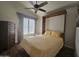 Bedroom with a built-in murphy bed and ceiling fan at 8700 E University Dr # 2020, Mesa, AZ 85207